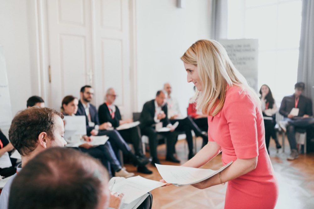 Michaela facilitating a workshop with a seated group