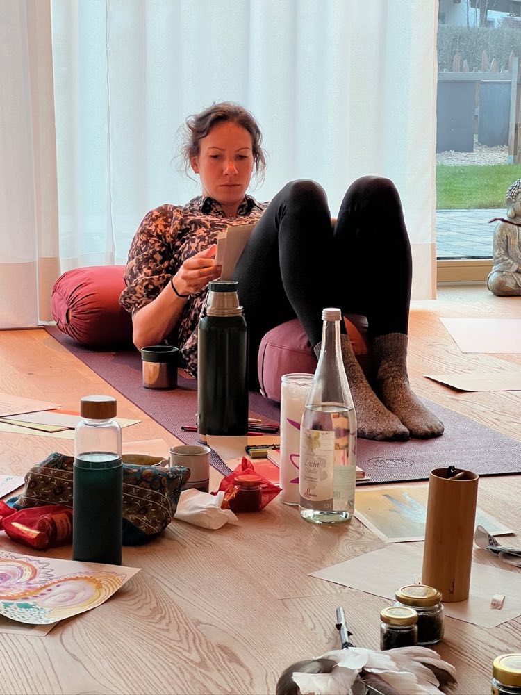 A participant at a workshop with journal and mat