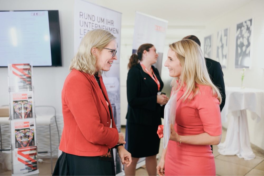Two participants in conversation at an event