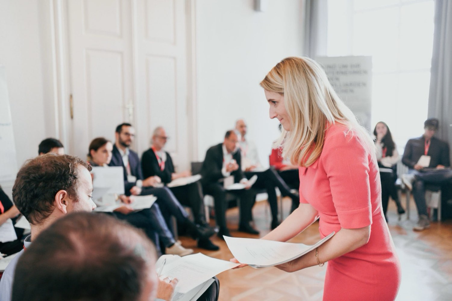 Michaela facilitating a workshop with a seated group